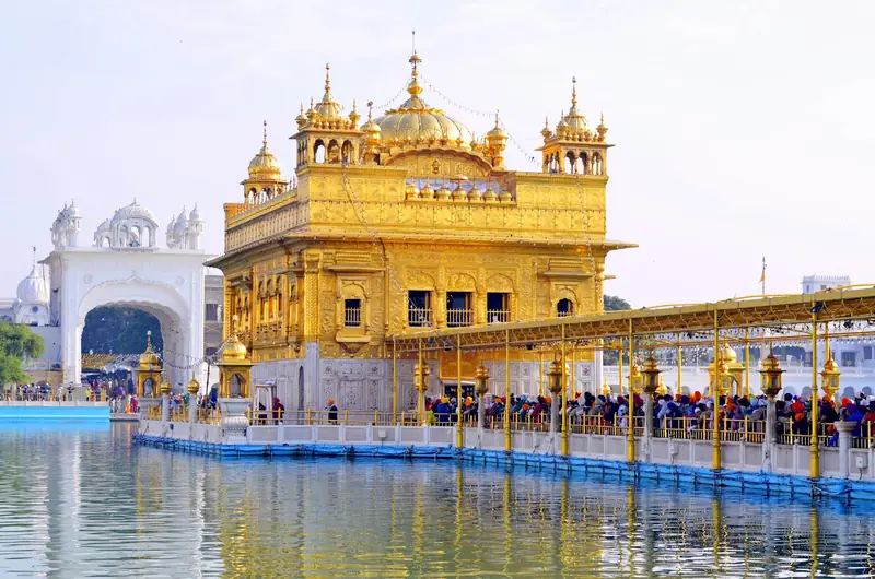 The Golden Temple in Amritsar with pilgrims on the causeway over the sacred pool