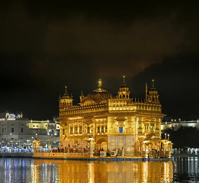 The Golden Temple lit up at night and reflected in its pool, Amritsar