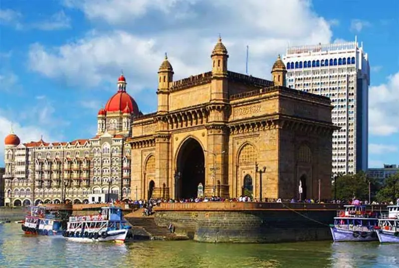 The Gateway of India in Mumbai with boats in the harbour