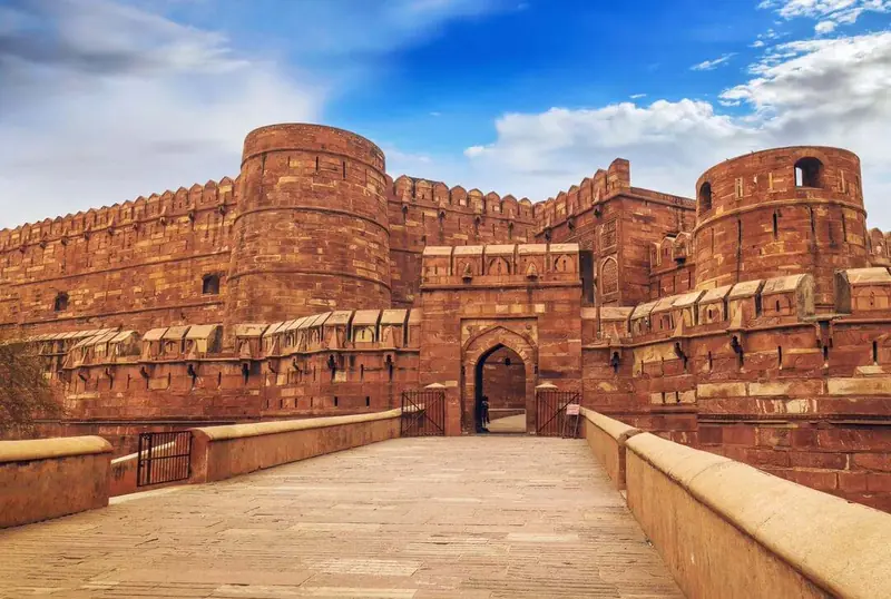 Red sandstone walls and entrance bridge of Agra Fort